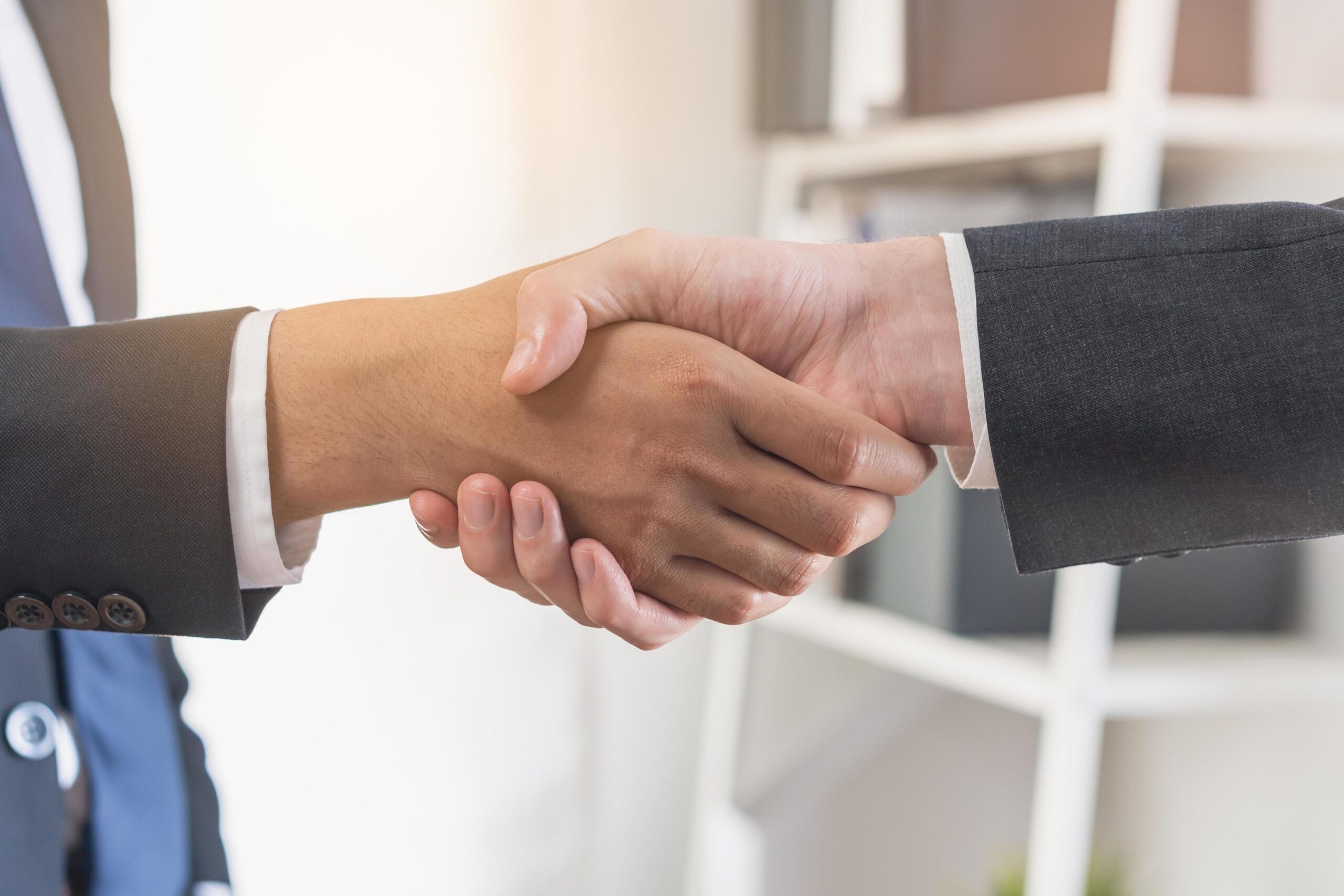 support business people happy asian young man in suit making handshake shake hand together with partnership customer or colleague after is done successful worker meeting congrats merger free photo scaled